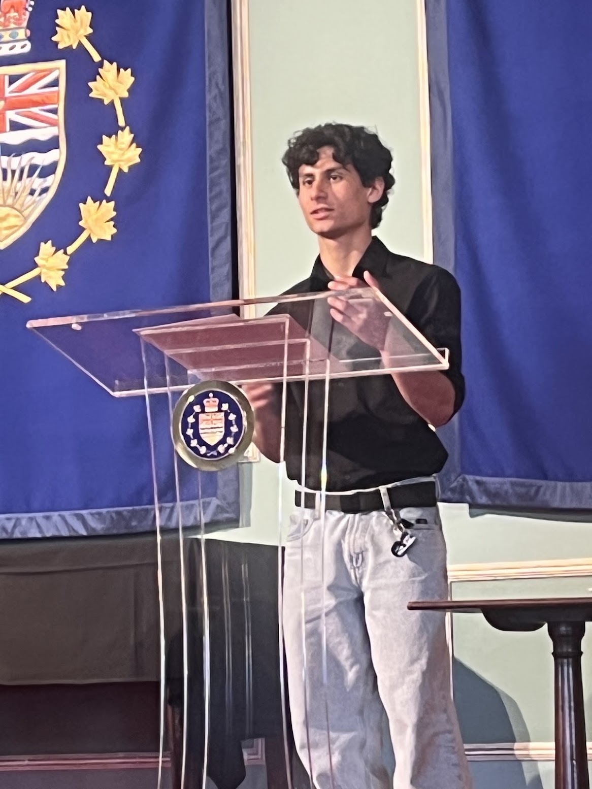 Nirmay Singh speaking at a podium